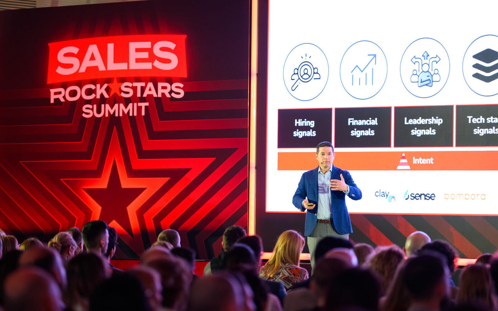 Scott on stage at Brand Minds Sales Rockstars Summit with signals model slide